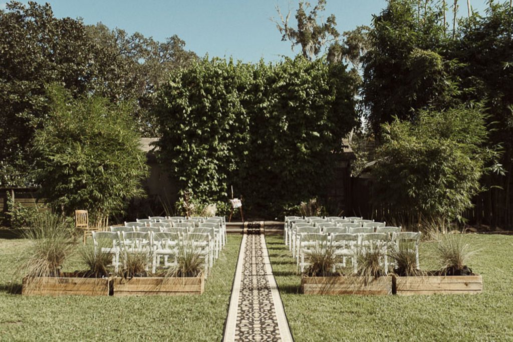 outdoor wedding venue with chairs and a aisle runner