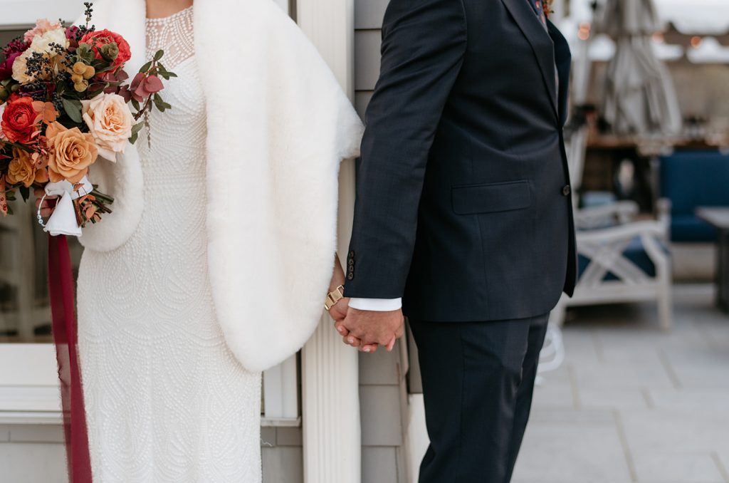 bride and groom holding hands