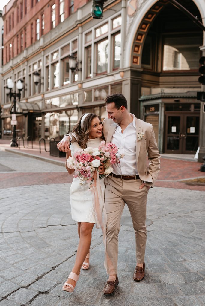 bride and groom walking downtown