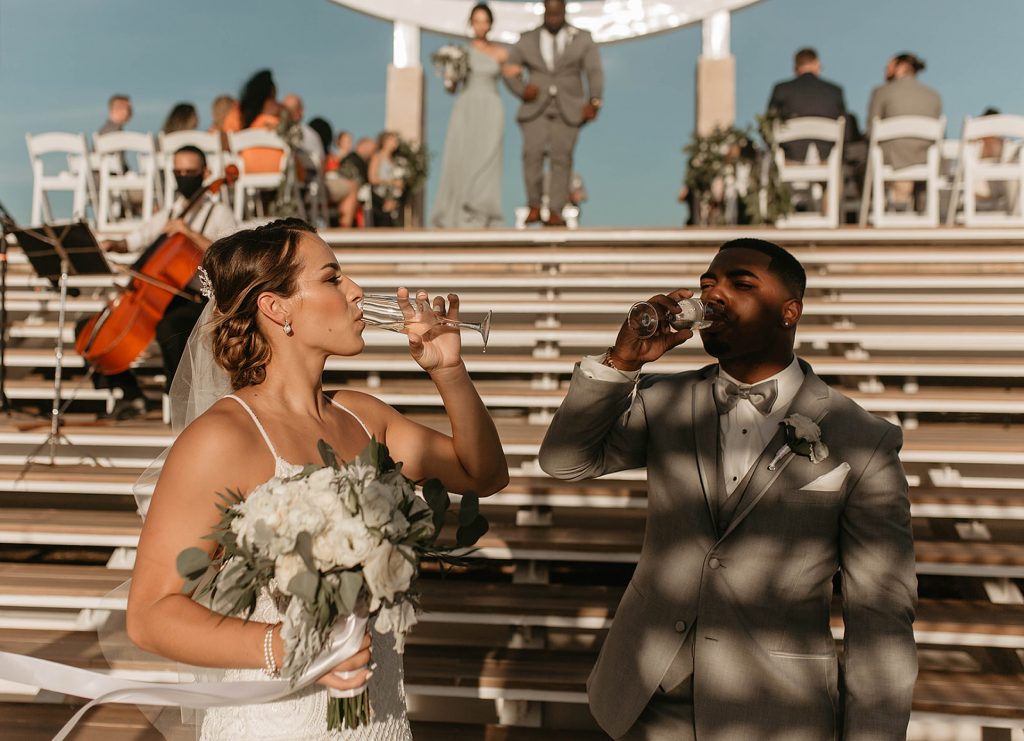 bride and groom drinking champagne