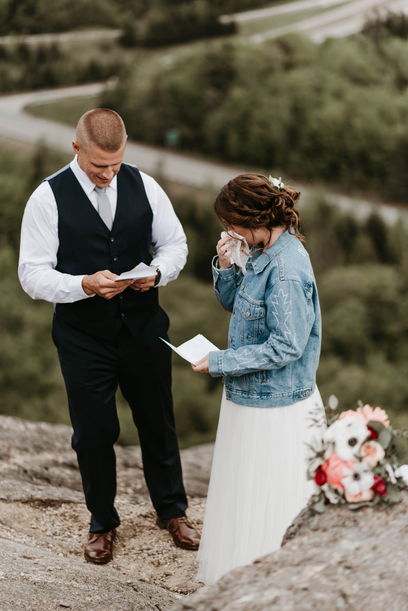 Couple reading vows on mountaintop