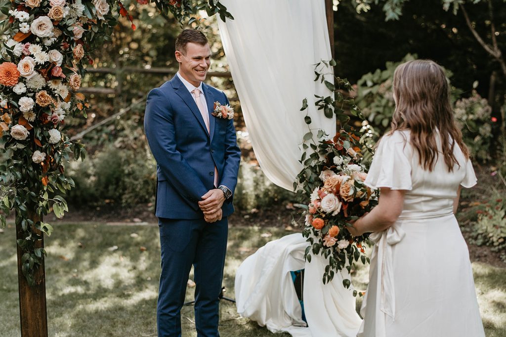 a bride and groom sharing a first look on their wedding day