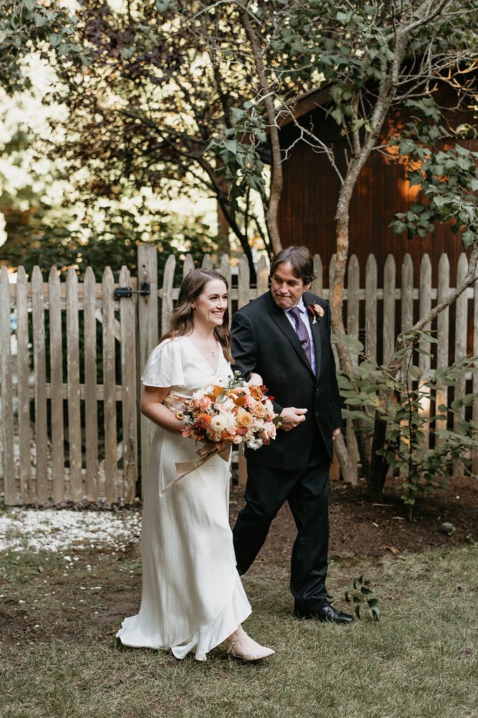 father walking down daughter down the aisle on her wedding day