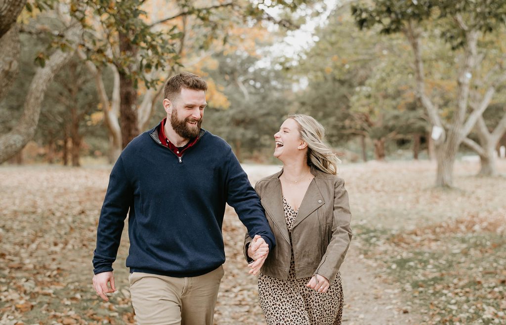 couple walking in the fall foliage
